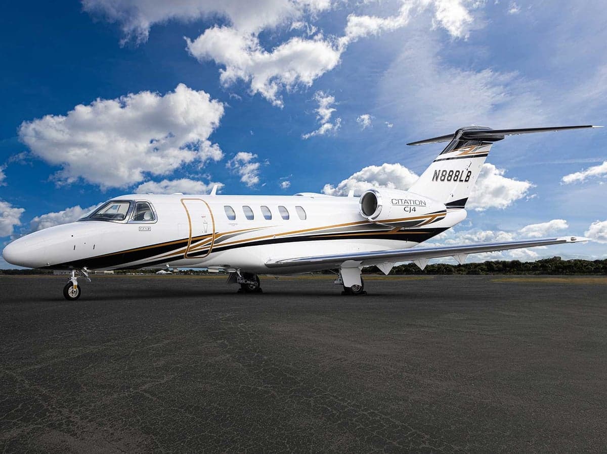 N888LB Citation CJ4 parked on the tarmac with a white and gold paint scheme.