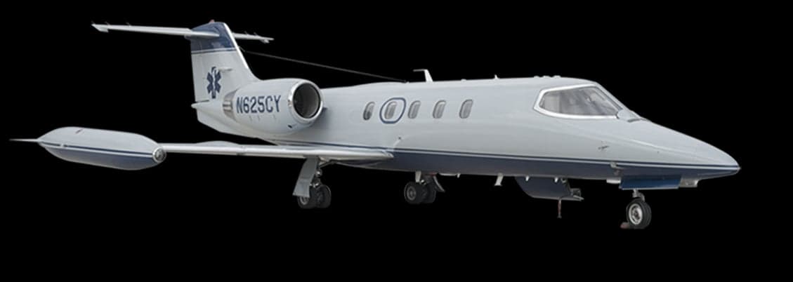 A gray Learjet air ambulance is shown against a black background.
