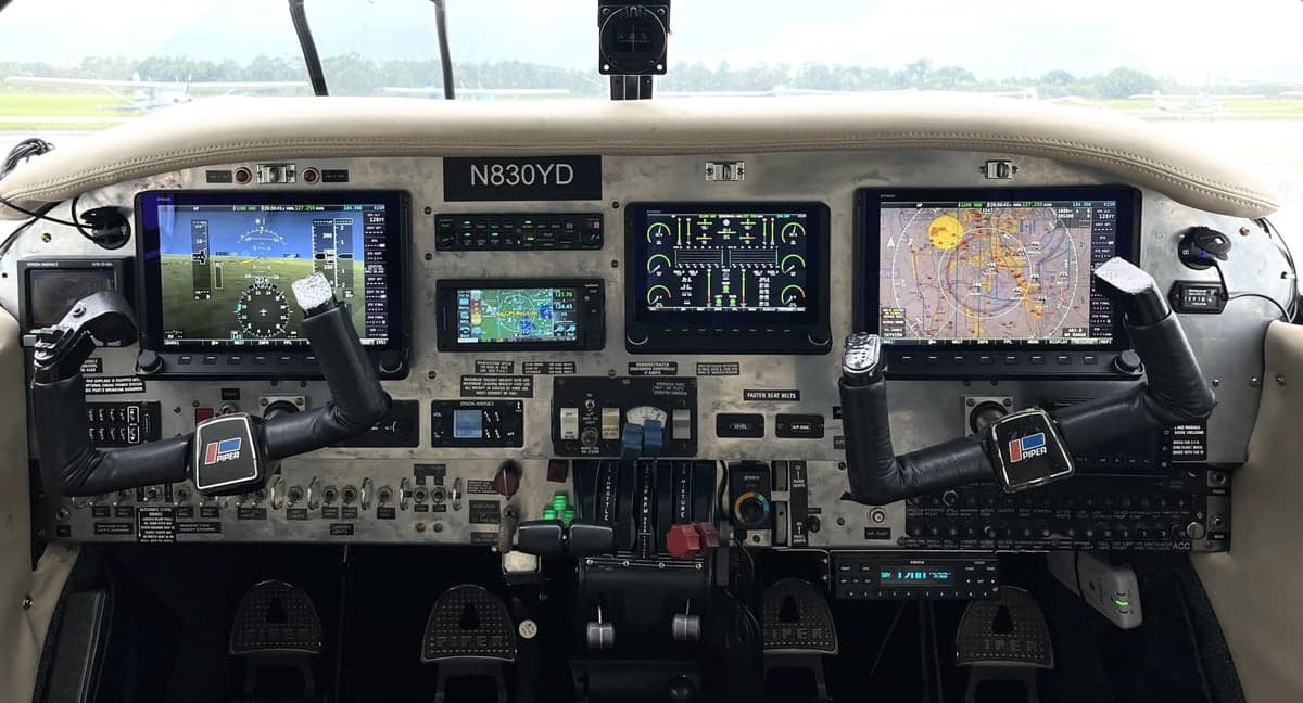 The cockpit of the Piper Seneca II N830YD features modern avionics and controls.