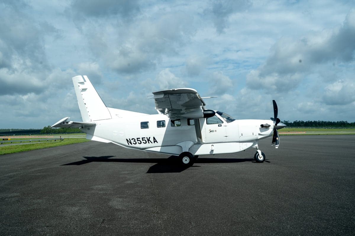 A white Quest Kodiak 100 aircraft, registration N355KA, viewed from the side on an asphalt tarmac.