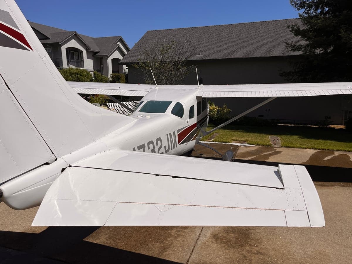 A rear quarter view of the Cessna Skymaster N732JM on the ground.