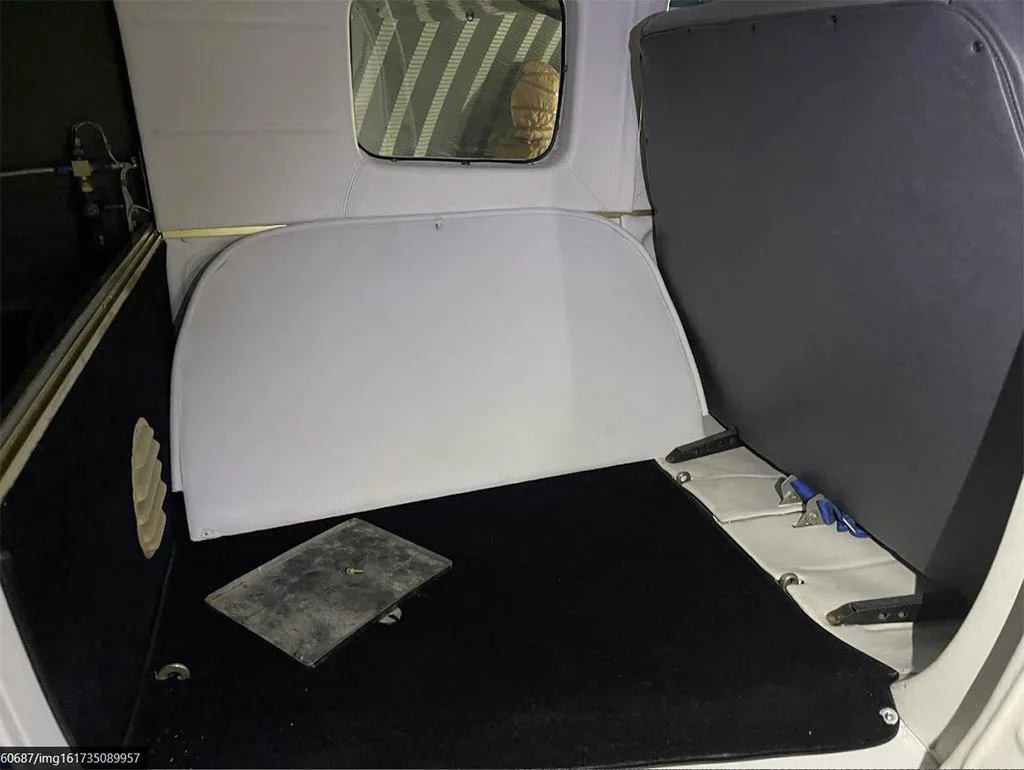 The grey and black baggage compartment or cargo area of the aircraft.