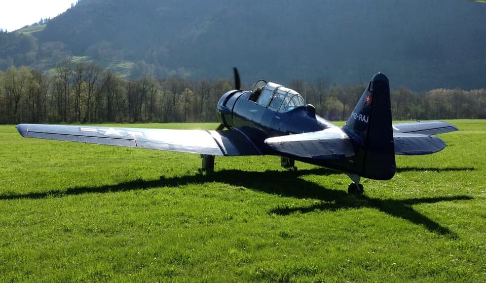 Close-up of a blue North American T-6 Texan aircraft on the ground.