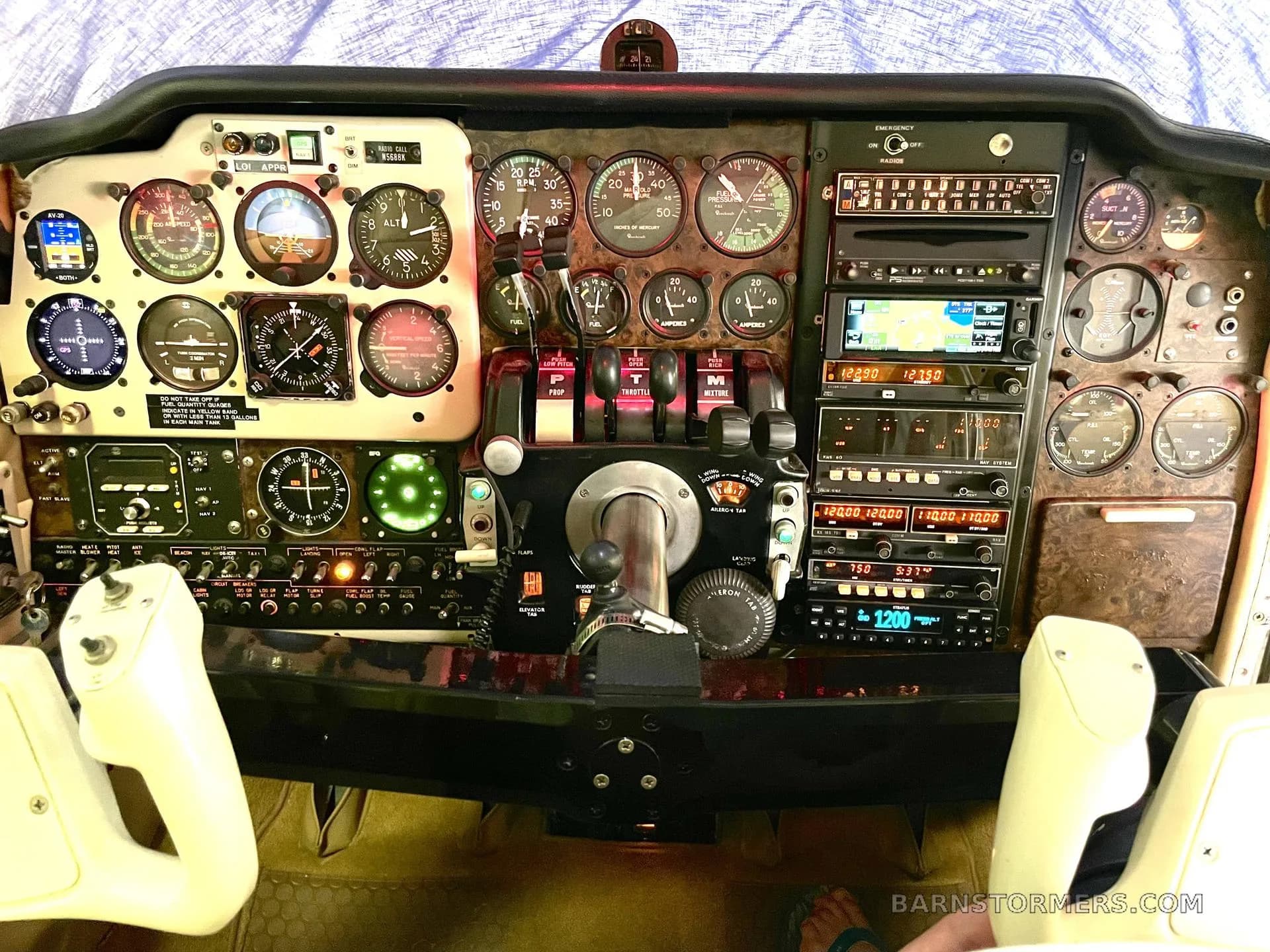 The detailed instrument panel and controls of a twin-engine aircraft, featuring analog gauges and digital displays.