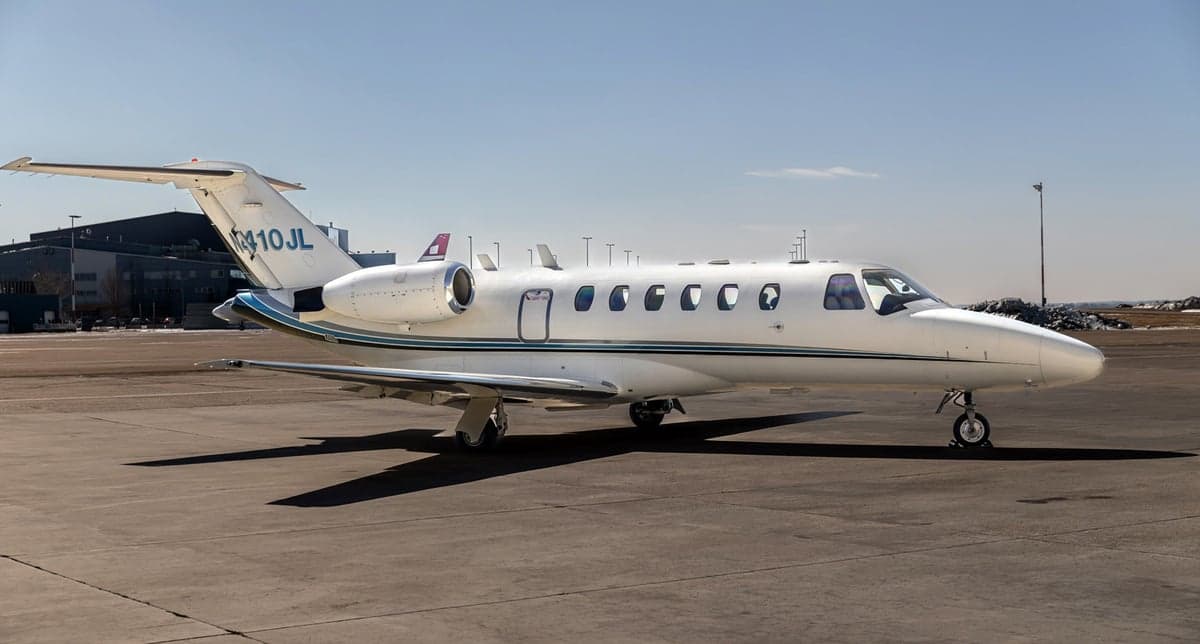 Front view of a Cessna Citation jet showing the nose and engines.