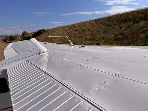 Close-up of the wing of the Cessna 210 aircraft N9451X.