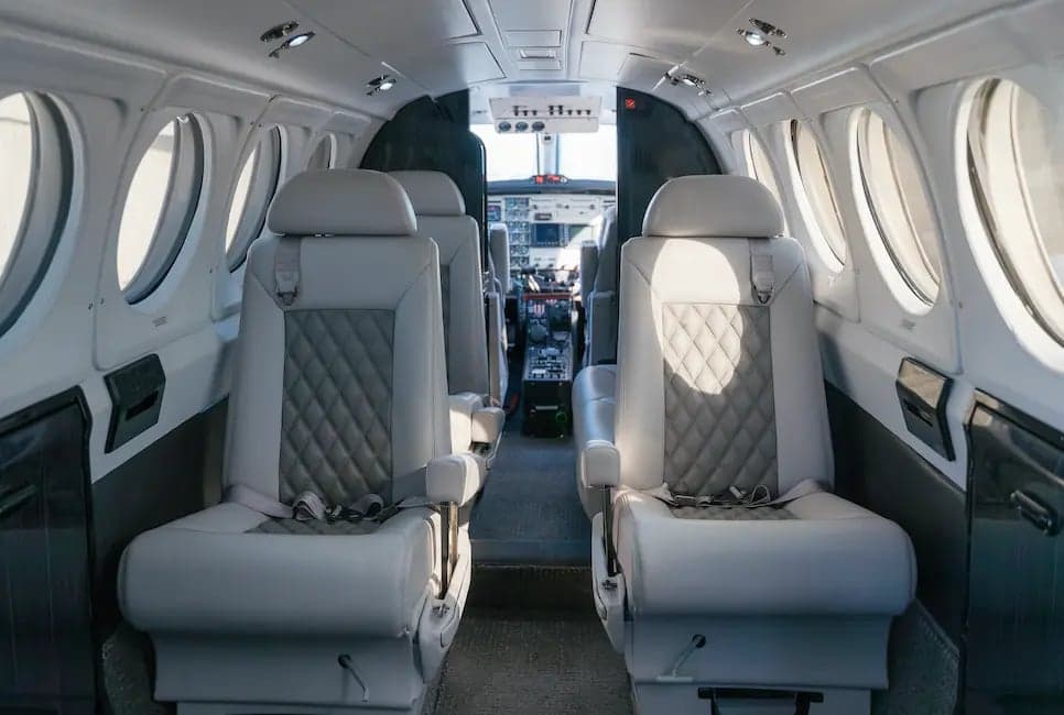 The interior of a King Air B200 aircraft, showing the seating arrangement.