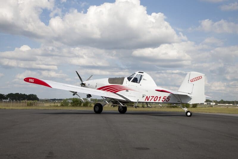 Side view of a Thrush 510G crop duster on the ground.