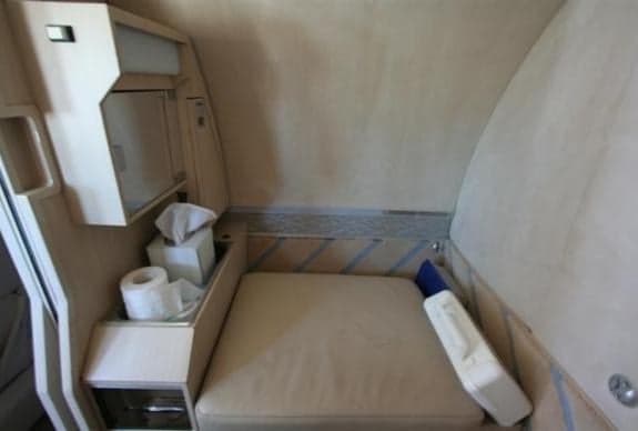 A small lavatory area is shown inside the aircraft.
