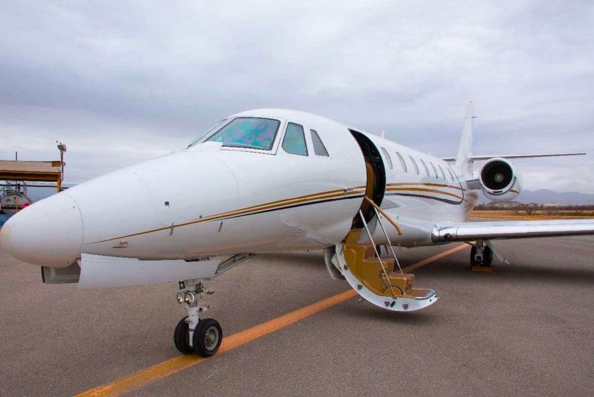 Side view of the aircraft with the door open and steps extended.