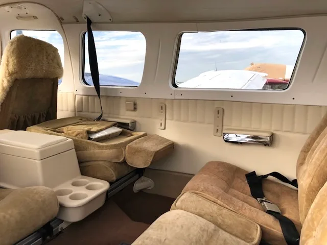 View of the aircraft's cabin with tan seats and interior panels.