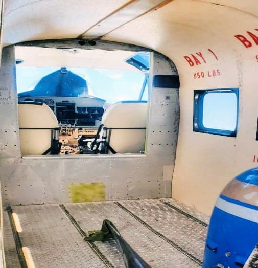 View of the cockpit from inside the cabin of the aircraft.