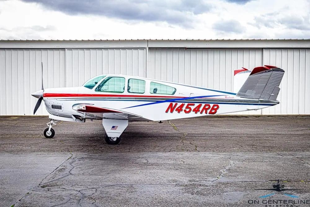 Side view of the Beechcraft Bonanza N454RB on the tarmac.