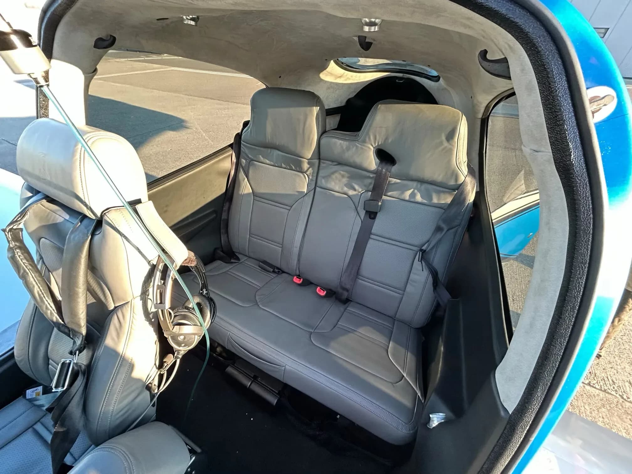 A wider view of the gray leather rear seats and cabin interior of a Cirrus SR22.