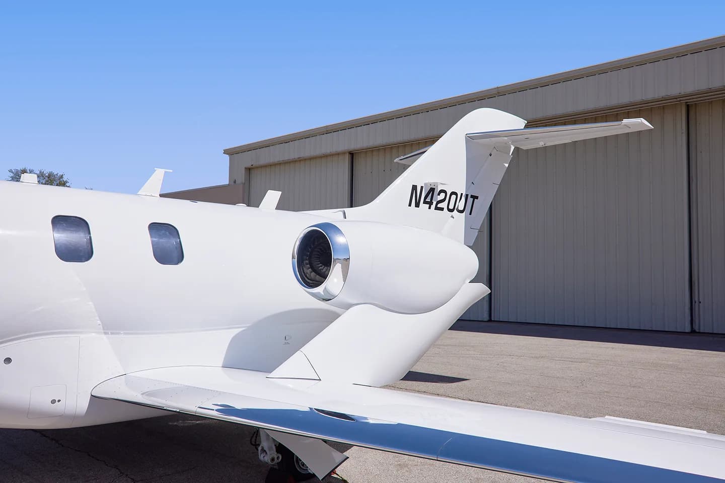 Close up of the tail and engine of a white HondaJet N420UT.