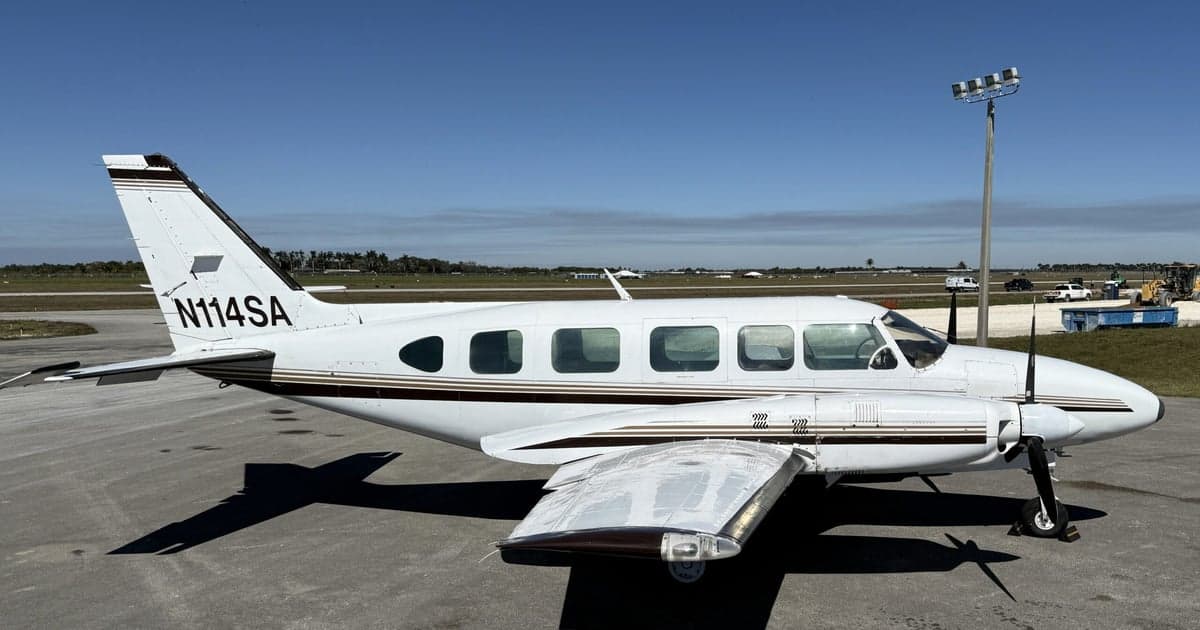N114SA is a white and brown twin-engine aircraft on the tarmac.