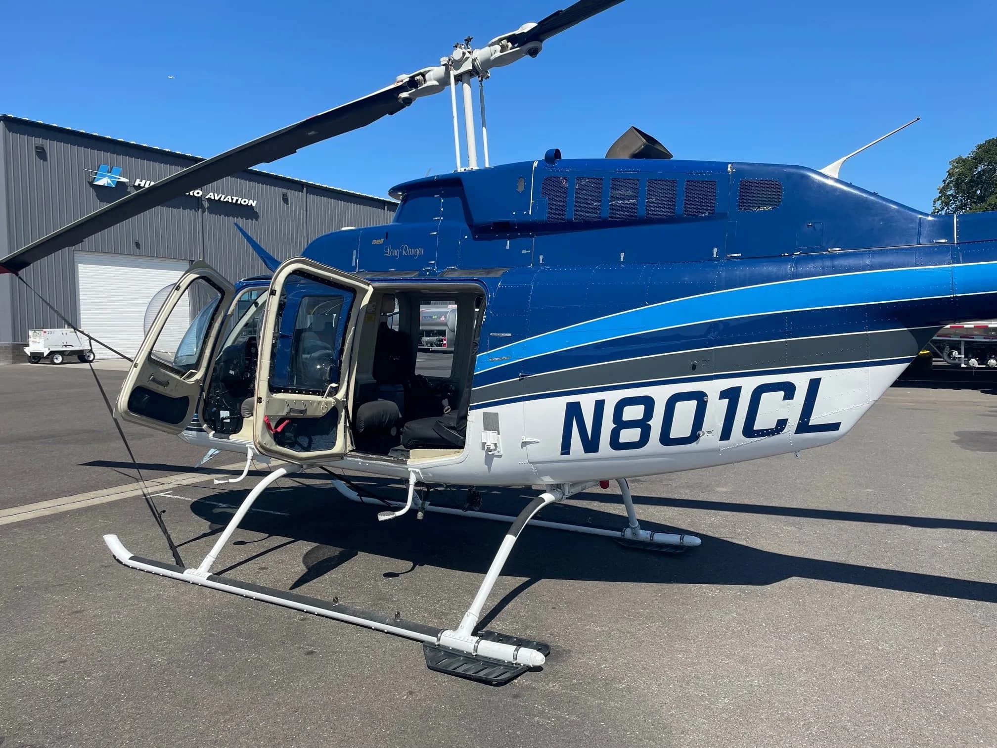 Bell 206B Jet Ranger with blue and white paint scheme, with open doors.