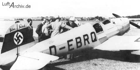 Black and white photo of a Bücker Bü 180 Student in flight.