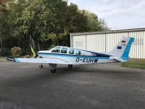 Side view of the D-EUHW aircraft parked on the tarmac.