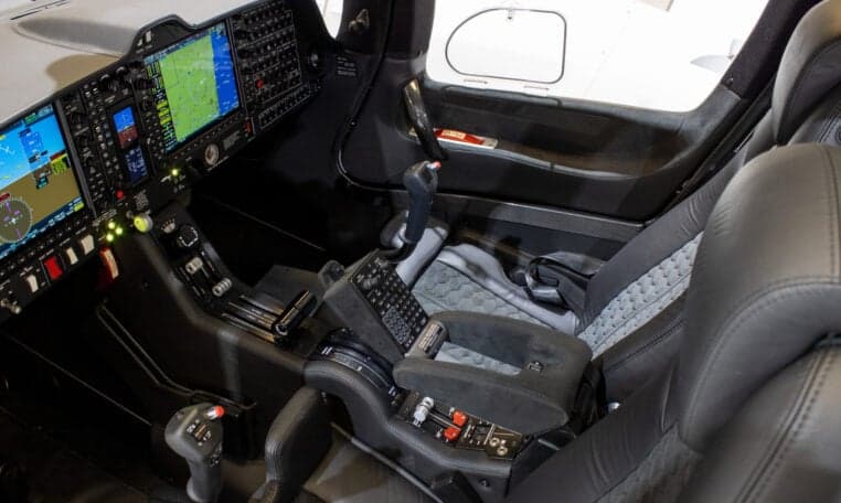 The cockpit of a Diamond DA62 aircraft showing the seats and controls.