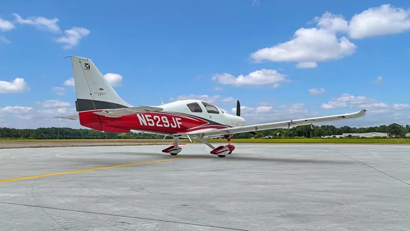 A Cirrus SR22 aircraft N529JF is parked on the runway.