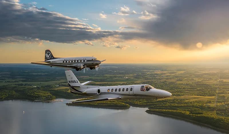 Cessna Citation CJ1+ aircraft N1966J flying in formation with a vintage DC-3.