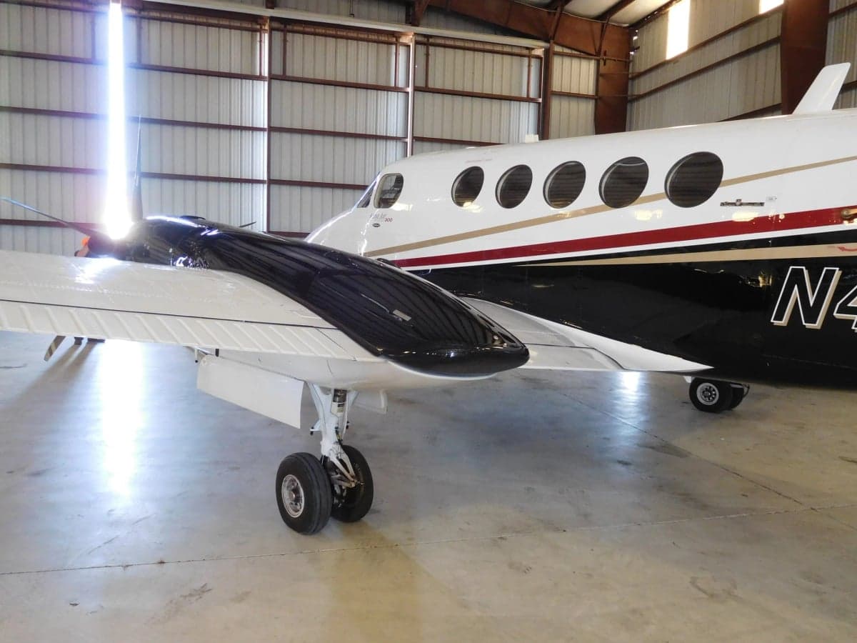 Close up of the wing and fuselage of N494MA King Air.