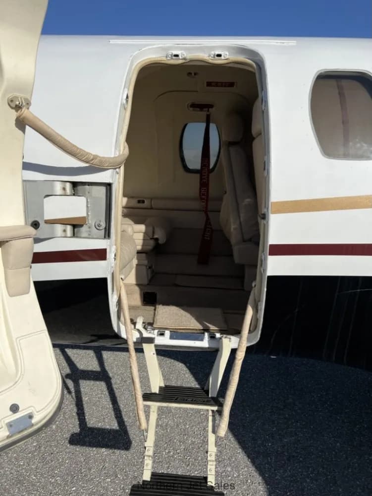 View of the interior of a jet from the open doorway with stairs.