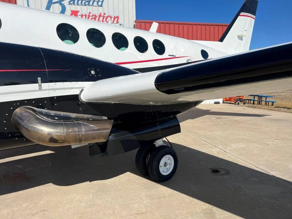 Close up of the side of a Beechcraft King Air with black and white paint scheme.