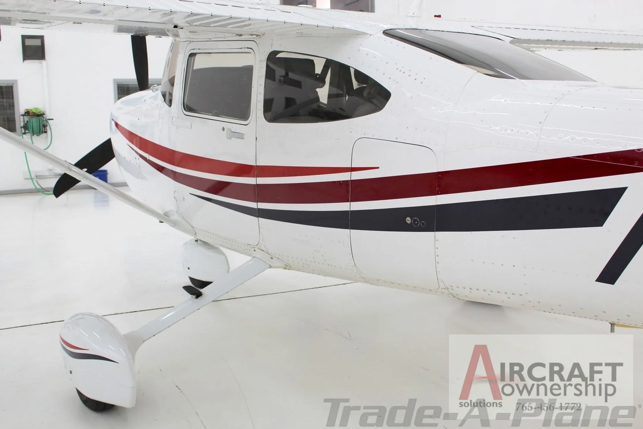 A side view of the fuselage of the Cessna Skylane N6768R, showing the main cabin door area.