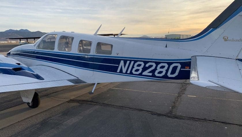 Side view of Beechcraft Baron N18280 on the tarmac.