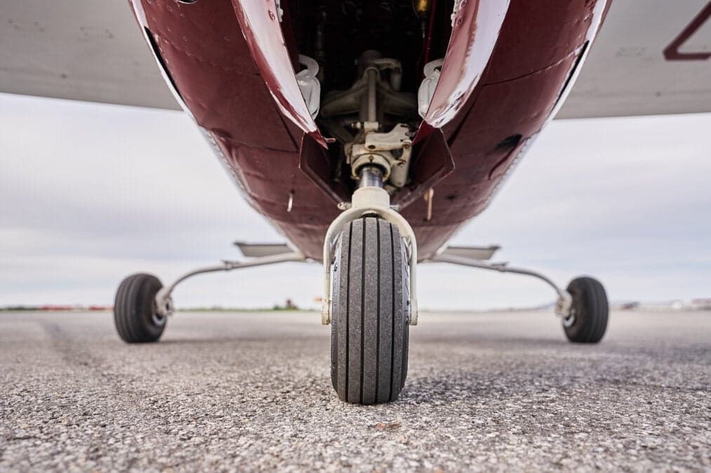 Close-up of the nose landing gear of an aircraft.