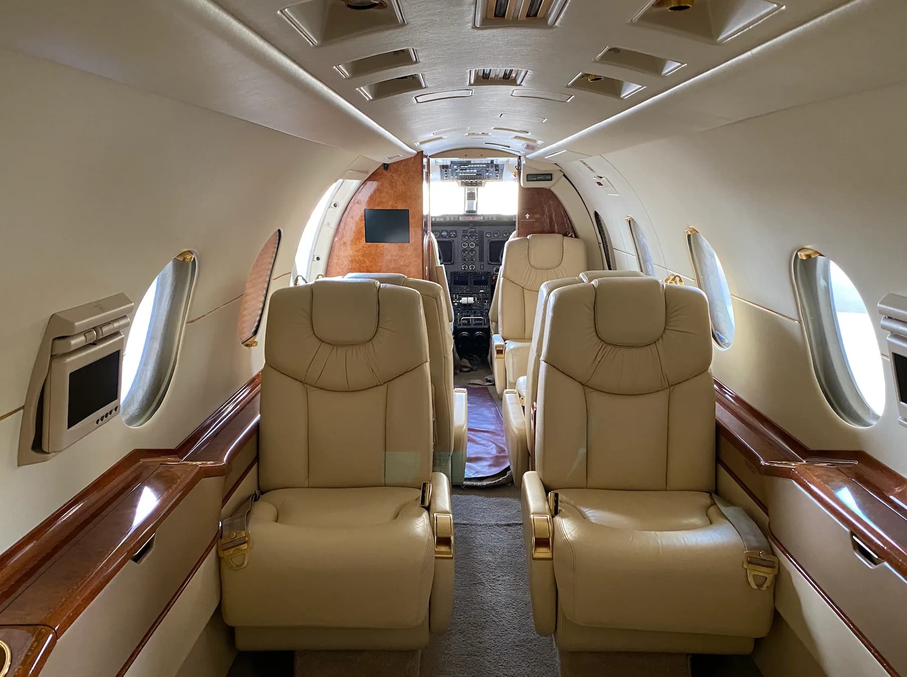 A view of the aircraft cabin showing the seats and cockpit.