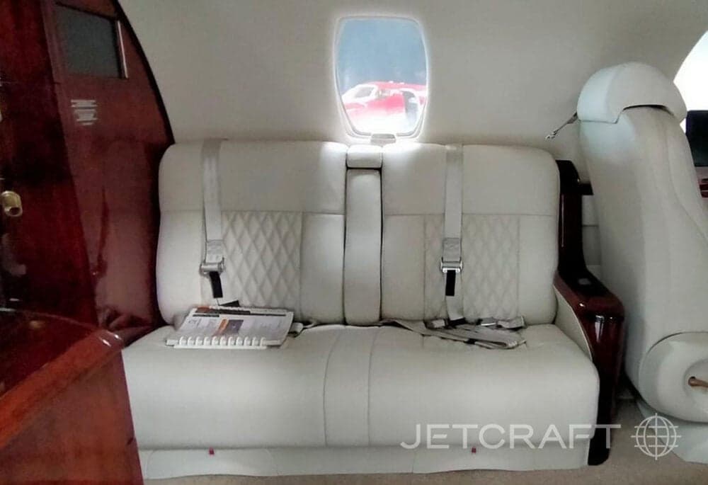 View of the interior cabin with white leather seats.