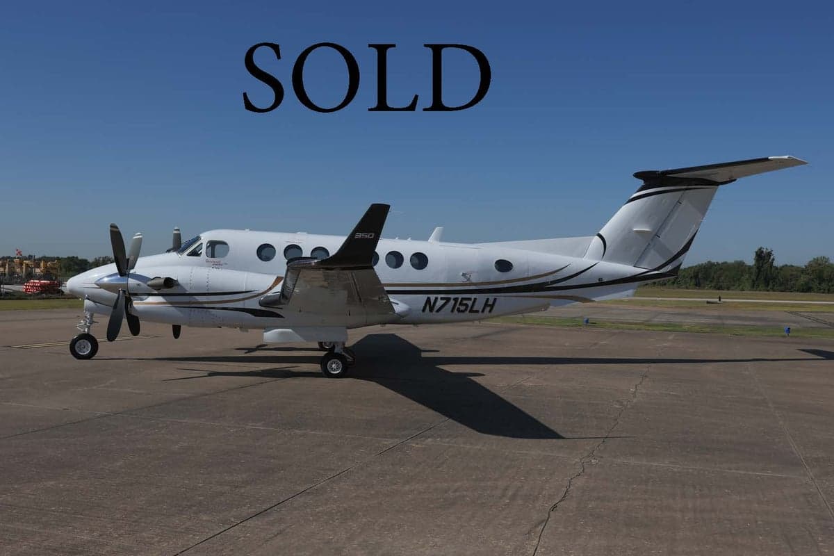 King Air 350 with registration N715LH parked on the tarmac with SOLD overlay.