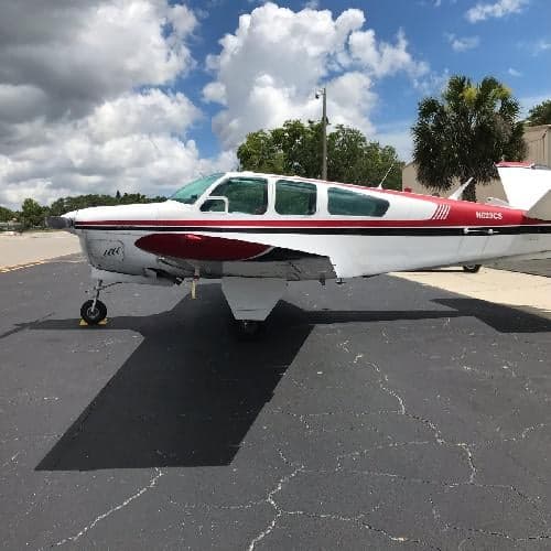 A Beechcraft Bonanza with registration N623CS is parked on the tarmac.