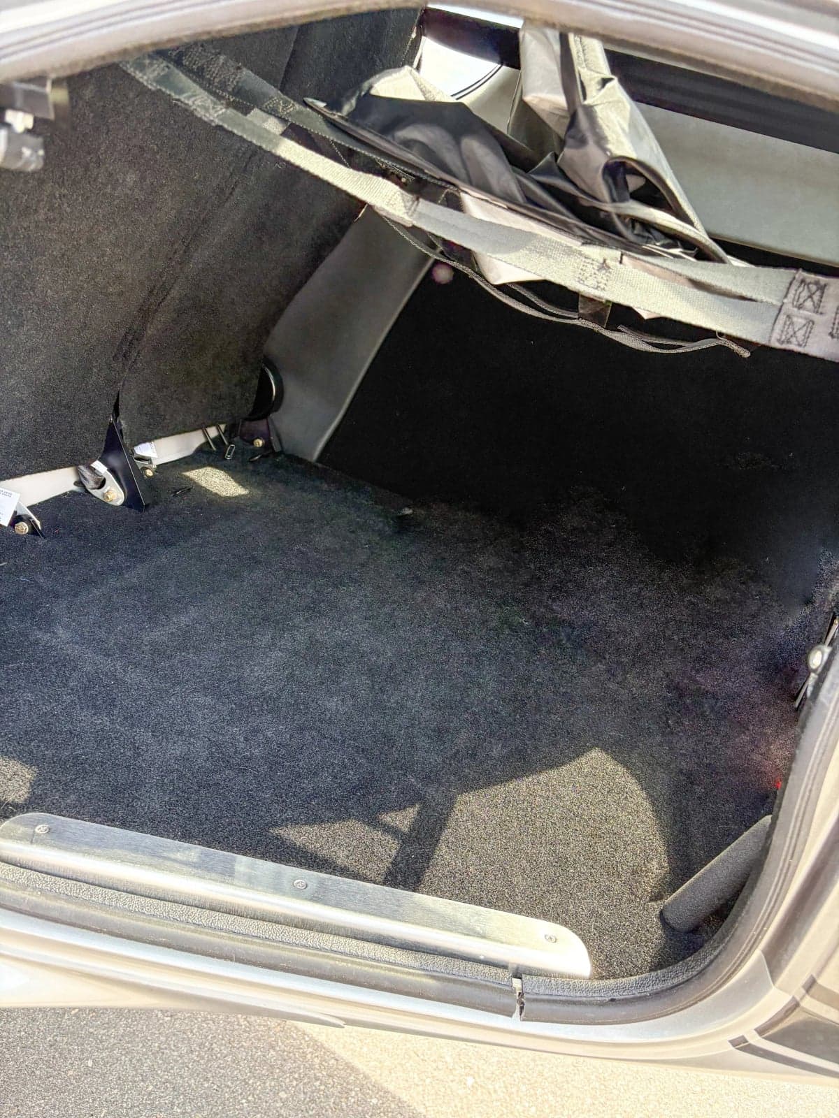 View of the Cirrus SR22T baggage compartment with black carpeting.