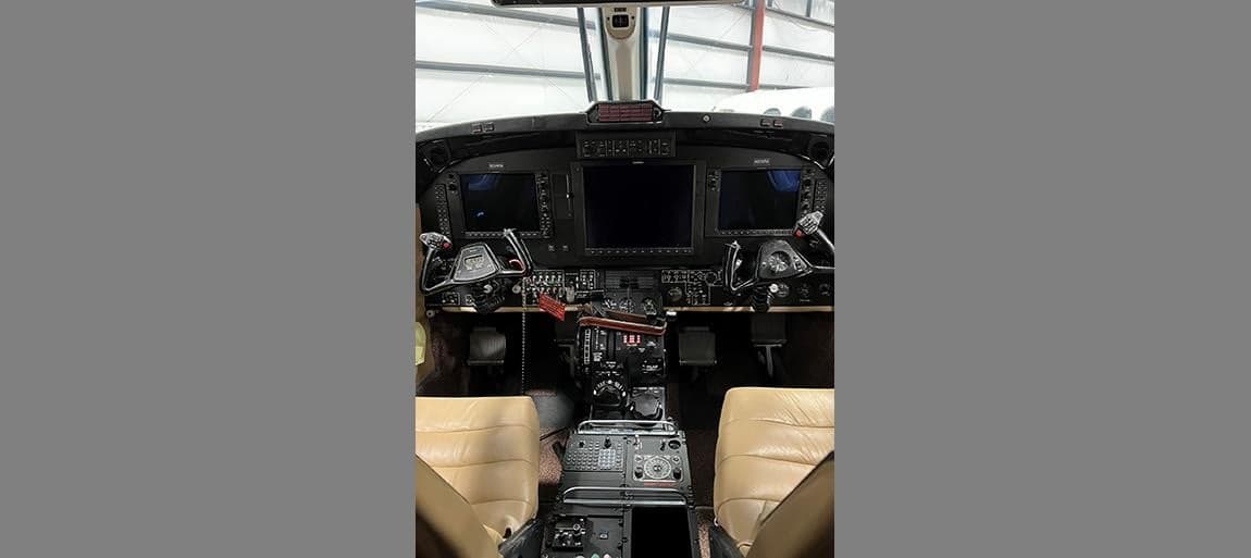 View of the aircraft cockpit with instrument panel and controls.