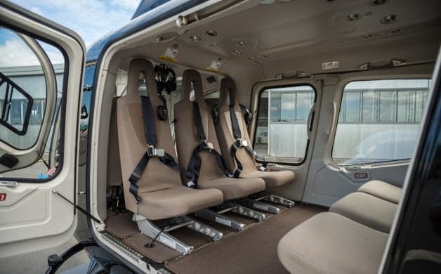 The cockpit of a helicopter with multiple display screens.