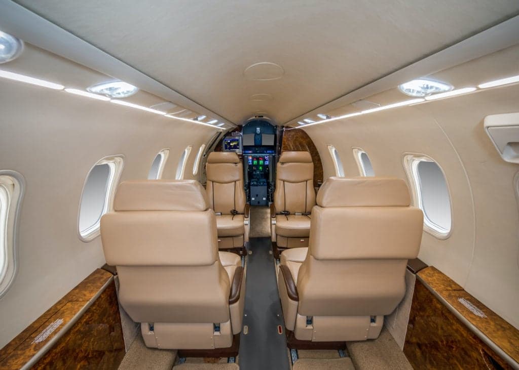 Interior view of the aircraft cabin with tan leather seats.