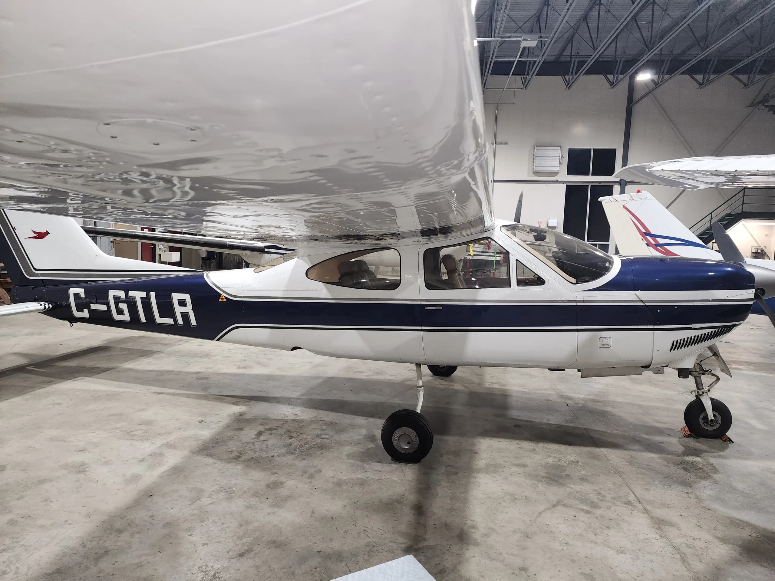 Side view of Cessna C-GTLR parked in a hangar.
