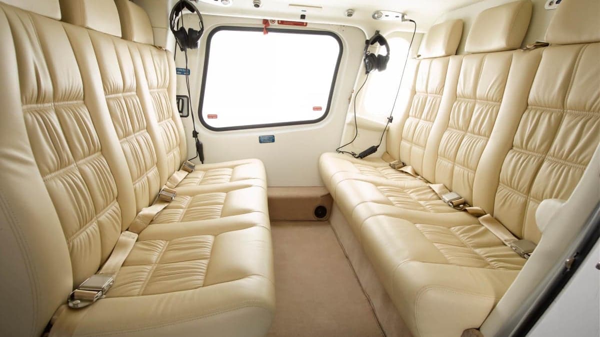 The interior of the AgustaWestland AW119 Koala helicopter features cream-colored leather seats.