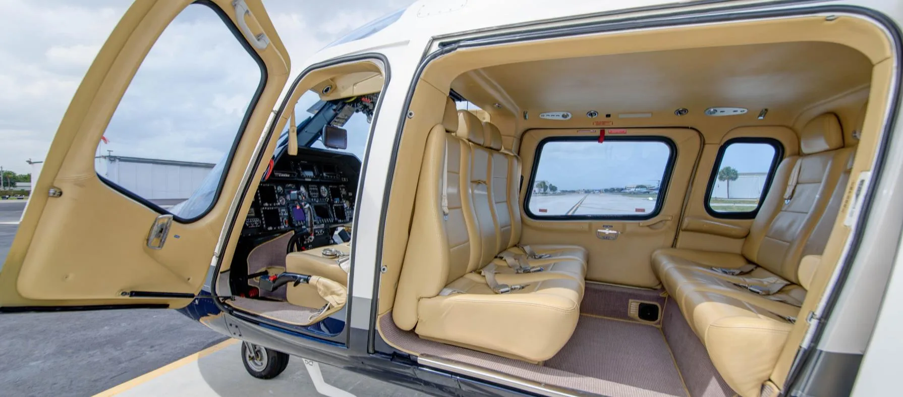 Interior view of the helicopter cabin with tan leather seats.