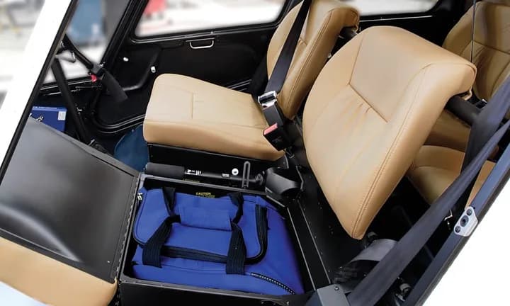 Interior view of the seats and storage in a Robinson R44 helicopter.