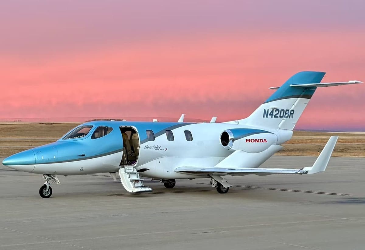 A HondaJet Elite S aircraft with a blue and white paint scheme is parked on the tarmac.