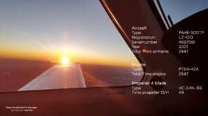 View from inside the cockpit of a Piper PA-46-500TP Meridian aircraft with the sun setting.