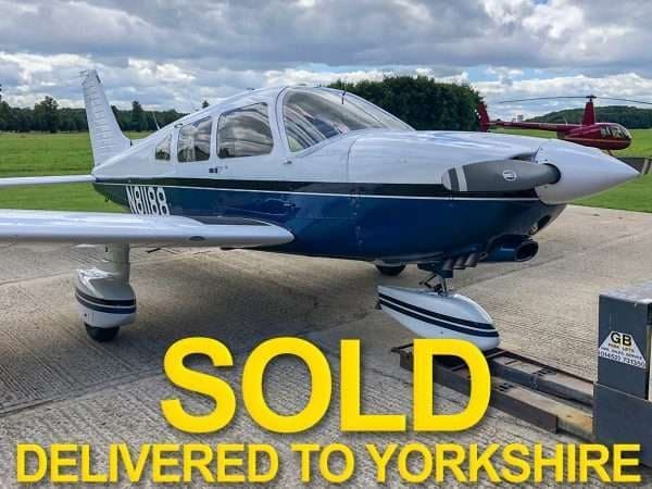 A Piper aircraft with blue and white paint scheme is marked as SOLD.