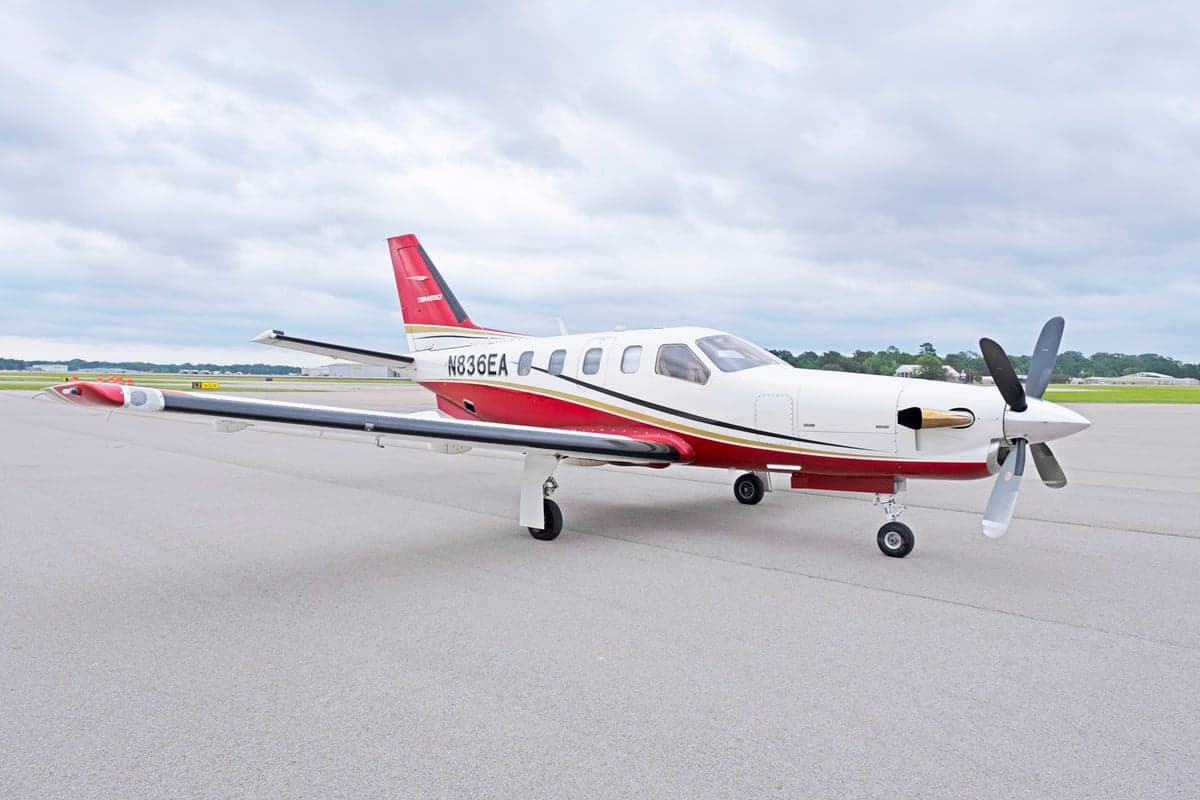 Side view of the TBM 850 aircraft N836EA on the tarmac.
