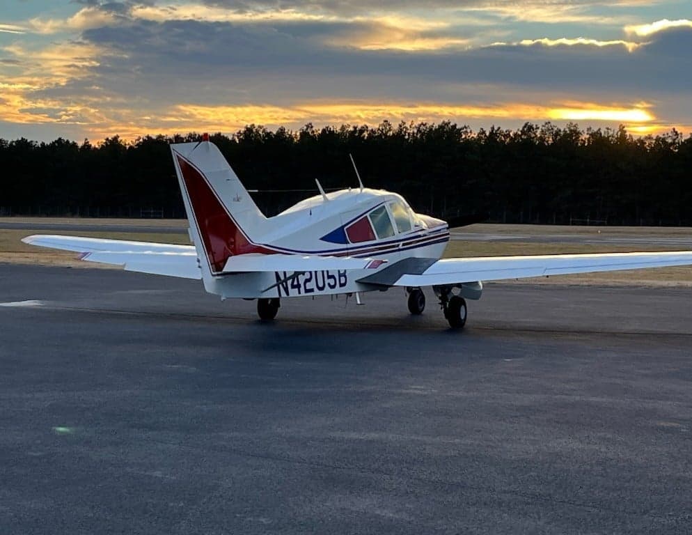 N4205B aircraft on the runway at sunset.