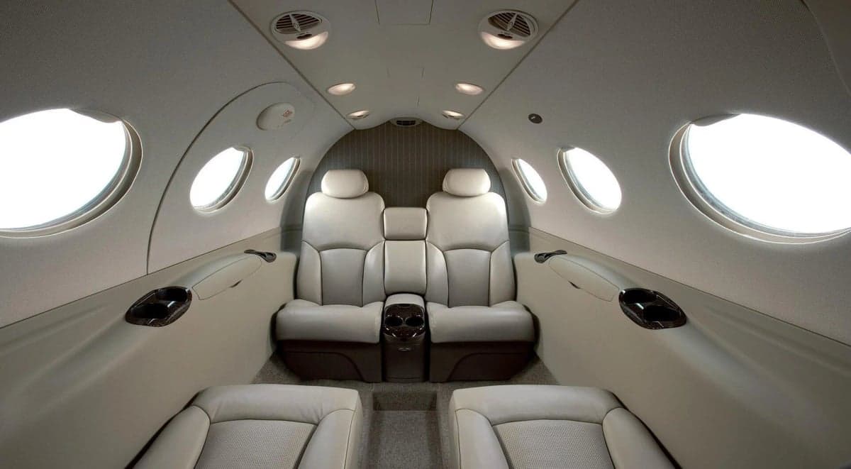 Interior view of a Cessna Citation Mustang cabin with light-colored leather seats.